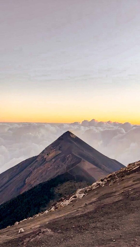 View of VOlcan FUego at sunrise with clouds in background