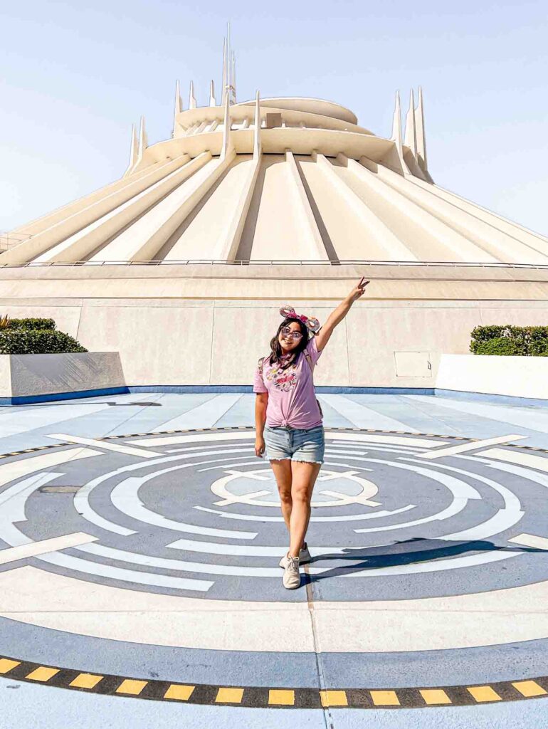 woman standing in front of Space Mountain facade