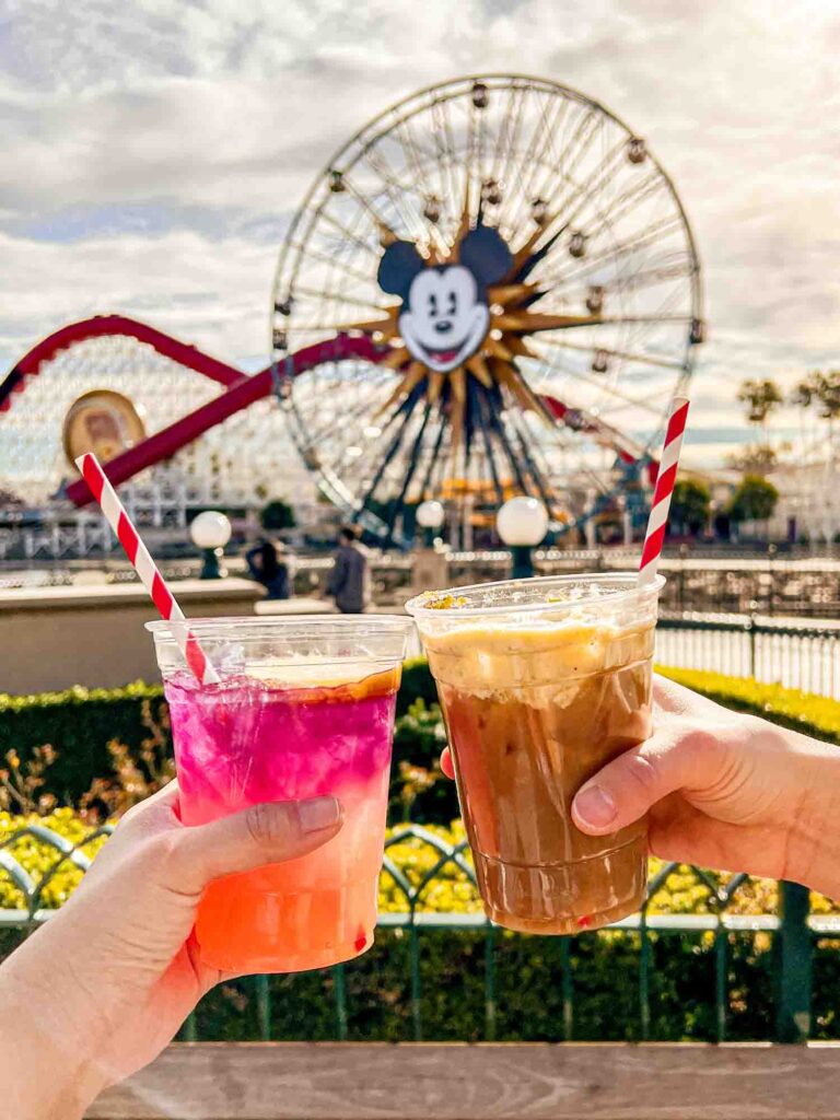 Cheersing cocktails in front of Mickey ferris wheel