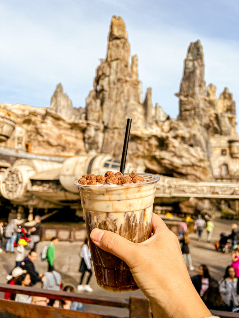 holding up cocoa puff coffee in front of galaxy's edge