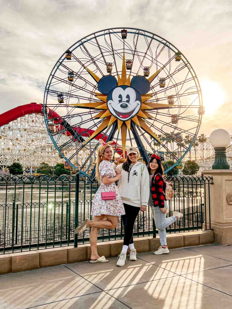 Three women standing in front of Mickey ferris wheel at California adventure